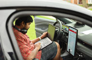 Person working on laptop from car