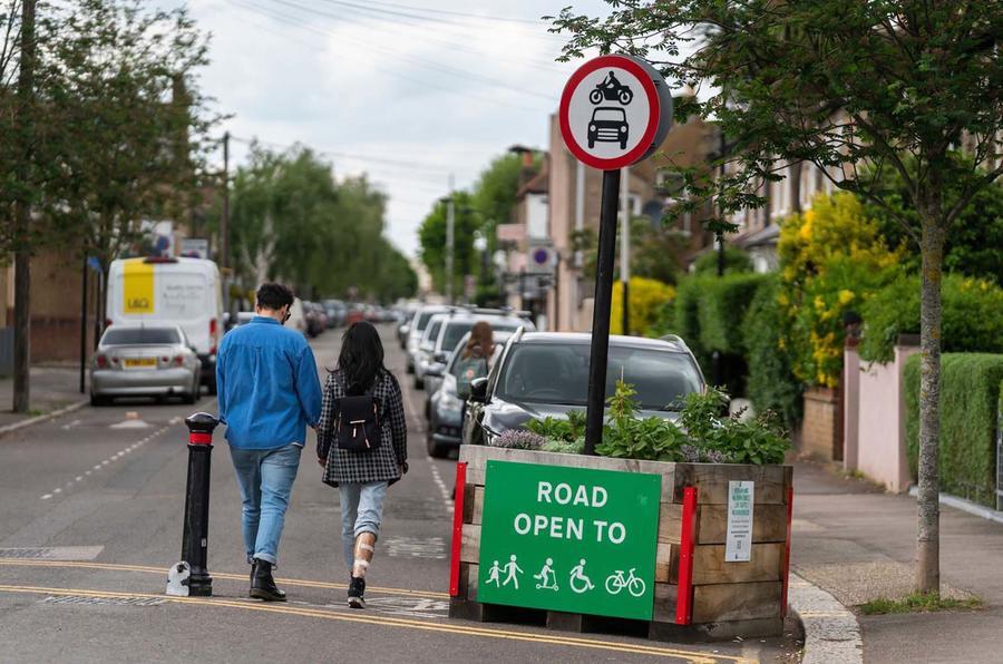 Two people walk through the entrance to a low-traffic zone