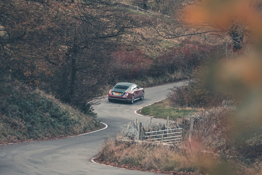 Rolls-Royce Spectre driving through countryside – rear