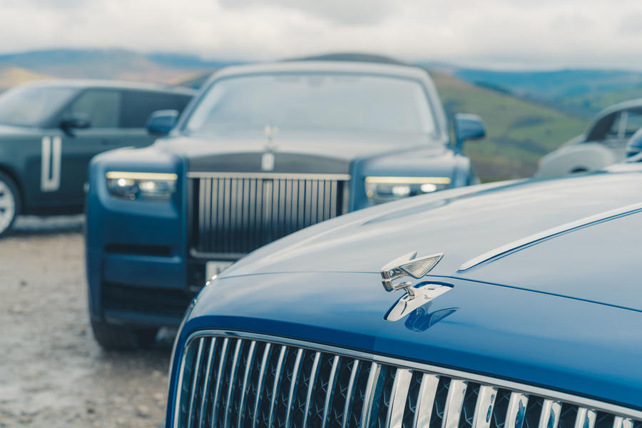 Bentley Flying spur bonnet badge with Rolls-Royce Phantom in background