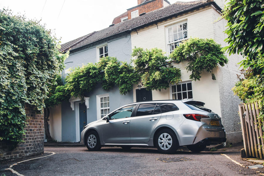 Toyota corolla commercial parked outside a house