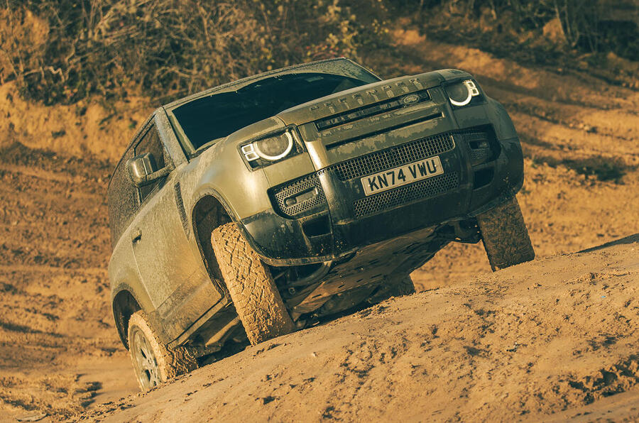 Land Rover Defender climbing muddy hill